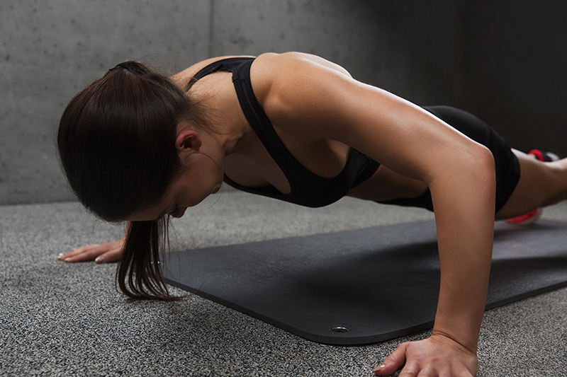 fitness-sport-people-exercising-concept-woman-doing-push-ups-gym