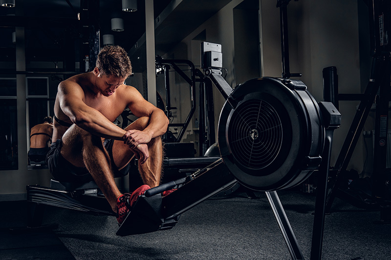 full-body-portrait-tired-sporty-male-after-workouts-power-exercise-machine-gym-club